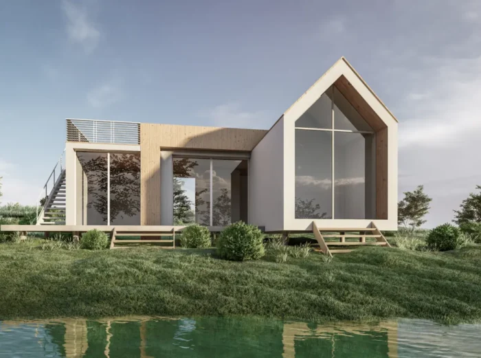 Modern two‑story house with large glass walls and a wooden accent, on a grassy bank by a calm pond.