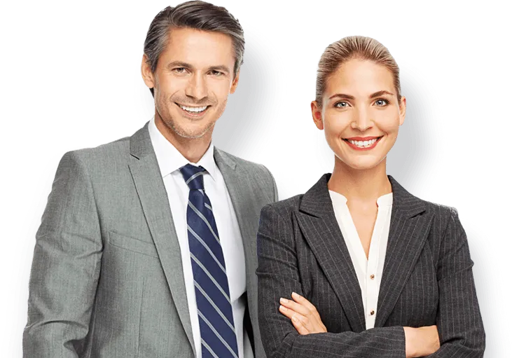Two smiling business professionals, a man in a gray suit and striped tie and a woman in a dark blazer, stand together.