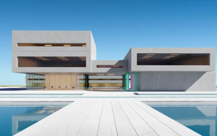 Modern concrete building with large rectangular windows, connected by a white walkway over a reflecting pool.